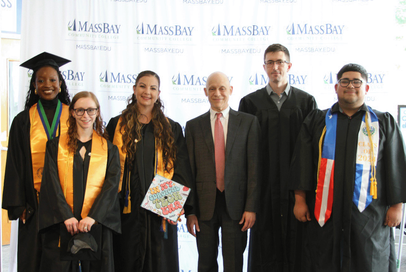 MassBay President David Podell with students at the 62nd Commencement ceremony