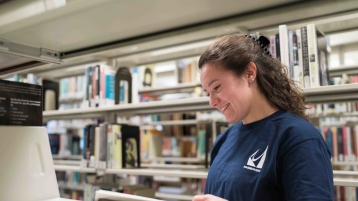 Student in Library Stacks